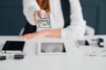 under the table jobs Do business online, get cash salary. Female extending dollar bills. Making money on internet. Income, payment, funds.
